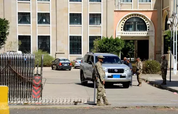 Houthi forces stand guard outside the Foreign Ministry in Sanaa on February 5. The US and UK struck dozens of targets in Yemen at the weekend, in response to the Houthis' repeated attacks on Red Sea shipping that have disrupted global trade. [Mohammed Huwais/AFP]