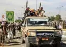 
Houthis elements armed with rocket-propelled grenade (RPG) launchers and assault rifles ride in the back of a pickup vehicle parading in Sanaa on February 7. [Mohammed Huwais/AFP]        