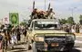 
Houthis elements armed with rocket-propelled grenade (RPG) launchers and assault rifles ride in the back of a pickup vehicle parading in Sanaa on February 7. [Mohammed Huwais/AFP]        