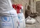 
Displaced Yemenis receive aid provided by the UN's World Food Program in the city of Taez on September 11. [Ahmad al-Basha/AFP]        