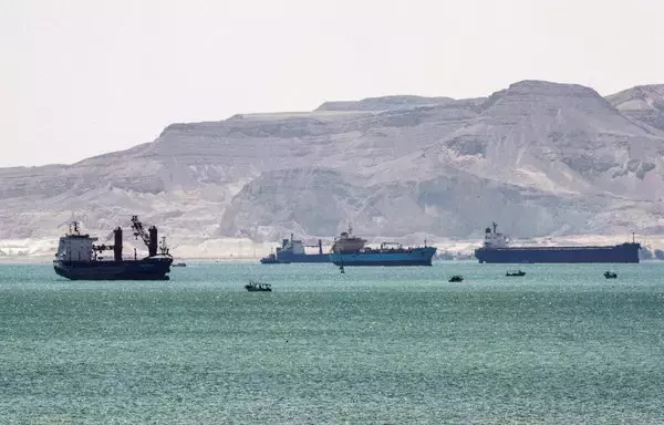 This picture taken March 28, 2021, shows tanker and freight ships near the entrance of the Suez Canal. [Ahmed Hasan/AFP]