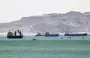 
This picture taken March 28, 2021, shows tanker and freight ships near the entrance of the Suez Canal. [Ahmed Hasan/AFP]        