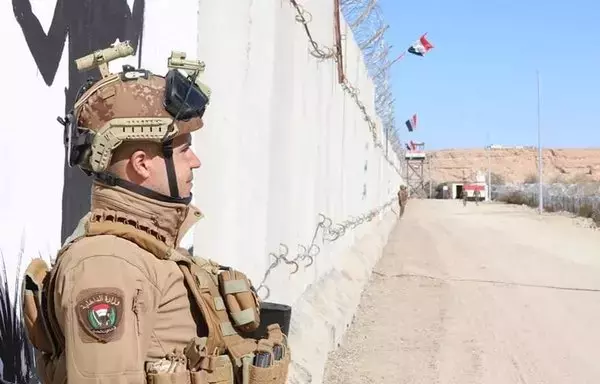 An Iraqi soldier stands guard at a newly opened border guard checkpoint along a concrete wall with Syria designed to curb smuggling operations, on January 28. [Iraqi Border Forces Command]