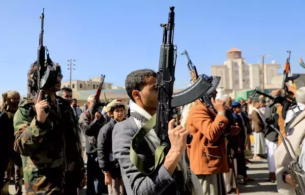Houthi fighters brandish their weapons during a march 'in solidarity with the Palestinians' in Sanaa on January 11. The Iran-backed group has been accused of exploiting the Palestinian cause for its own purposes. [Mohammed Huwais/AFP]