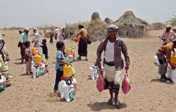 Yemenis displaced by the conflict receive food aid and supplies to meet their basic needs, at a camp in al-Hodeidah province's Hays district on March 29, 2022. [Khaled Ziad/AFP]