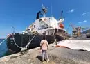 
US-owned, Greek-flagged ship Sea Champion is pictured in the city of Aden, on February 21, a day after it was targeted by the Houthis in the Gulf of Aden. [Saleh al-Obeidi/AFP]        