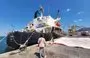 
US-owned, Greek-flagged ship Sea Champion is pictured in the city of Aden, on February 21, a day after it was targeted by the Houthis in the Gulf of Aden. [Saleh al-Obeidi/AFP]        