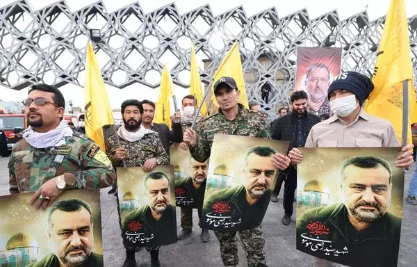 Mourners attend the funeral of Razi Mousavi, a senior commander in the Quds Force of Iran's IRGC who was killed on December 25 in an air strike in Syria, in Tehran, on December 28, 2023. [Atta Kenare/AFP]