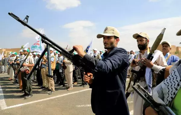 Armed Yemenis display smuggled weapons during a parade in Sanaa on March 9. [Mohammed Huwais/AFP]