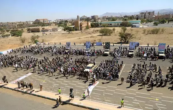 Armed Yemeni men chant slogans during a march in the Houthi-held Sanaa on March 7. [Mohammed Huwais/AFP]