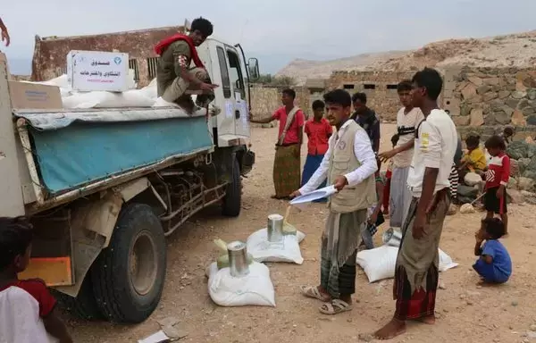 Yemenis on the island of Socotra receive food aid donated by the World Food Program last October. [World Food Program]