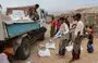 
Yemenis on the island of Socotra receive food aid donated by the World Food Program last October. [World Food Program]        