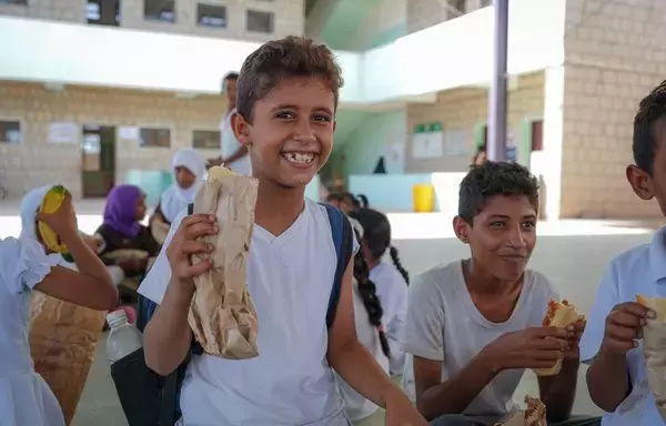 Students in Taez eat food provided by the World Food Program's school feeding program in January. [World Food Program]