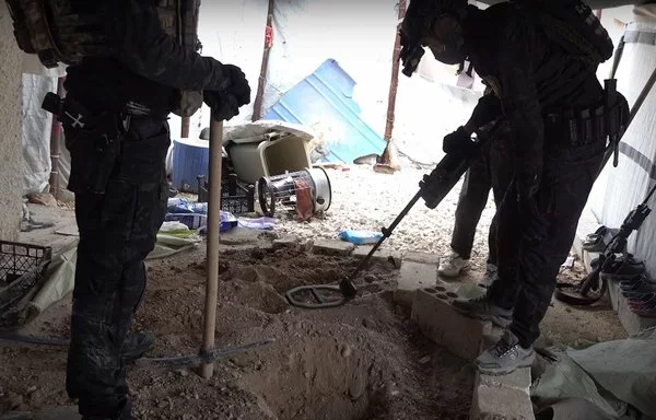 Anti-Terror Units of the Syrian Democratic Forces conduct a weapon sweep in al-Hol camp in this screenshot, taken from a video posted online on February 2. [Syrian Democratic Forces]