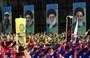 
Scouts loyal to Hizbullah salute during a procession in Lebanon's southern city of Nabatiyeh on August 12, 2022, as they march past posters of Hizbullah's slain military leader Imad Moghniyeh, current leader Hassan Nasrallah, Iran's leader Ali Khamenei and late supreme leader Rouhollah Khomeini. [Mahmoud Zayyat/AFP]        