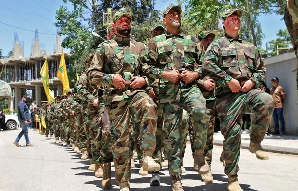 Hizbullah fighters take part in a parade in the eastern Bekaa Valley on May 25, 2022. [AFP]