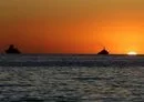 
Vessels are moored in the Mediterranean sea at sunset, off the coast of the Syrian port city of Tartous, on July 24, 2022. [Louai Beshara/AFP]        