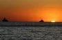 
Vessels are moored in the Mediterranean sea at sunset, off the coast of the Syrian port city of Tartous, on July 24, 2022. [Louai Beshara/AFP]        