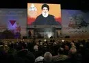 
People watch Hizbullah chief Hasan Nasrallah deliver a televised speech to mark the anniversary of the killing of IRGC Quds Force commander Qassem Soleimani in Beirut's southern suburb on January 3. [Anwar Amro/AFP]        