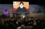 
People watch Hizbullah chief Hasan Nasrallah deliver a televised speech to mark the anniversary of the killing of IRGC Quds Force commander Qassem Soleimani in Beirut's southern suburb on January 3. [Anwar Amro/AFP]        