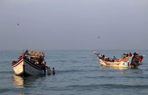 Yemeni fishermen arrive to unload their catch from a boat in al-Khokha district on the southern edge of the Red Sea city of al-Hodeidah on January 16. [Khaled Ziad/AFP]