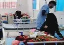 
Parents sit beside their children who are suffering from hemolysis at the emergency department in Al-Sabeen Hospital in Sanaa. [Photo courtesy of Yazan Abdul Aziz]        