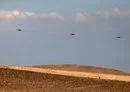 
Israeli air force heavy lift military transport helicopters fly over the southern Negev desert on April 14. [Ahmad Gharabli/AFP]        