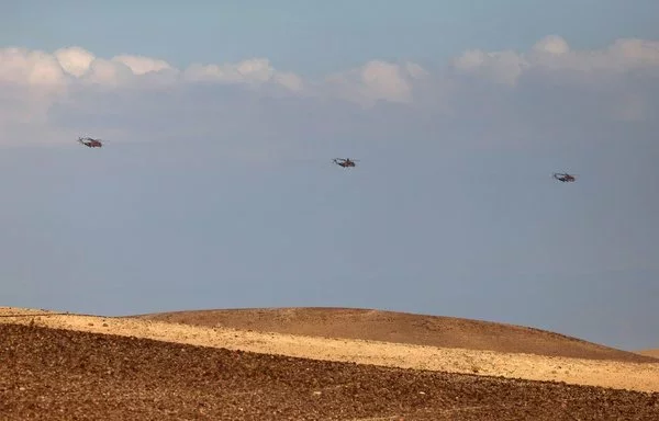 Israeli air force heavy lift military transport helicopters fly over the southern Negev desert on April 14. [Ahmad Gharabli/AFP]