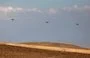 
Israeli air force heavy lift military transport helicopters fly over the southern Negev desert on April 14. [Ahmad Gharabli/AFP]        