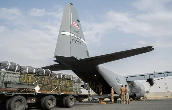 US Central Command personnel load bundles of food aid onto a C-130 aircraft to drop into northern Gaza on April 9. [CENTCOM]