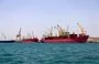 
Ships are docked for unloading in Yemen's Houthi-held port of al-Hodeidah last July 15. [Mohammed Huwais/AFP]        