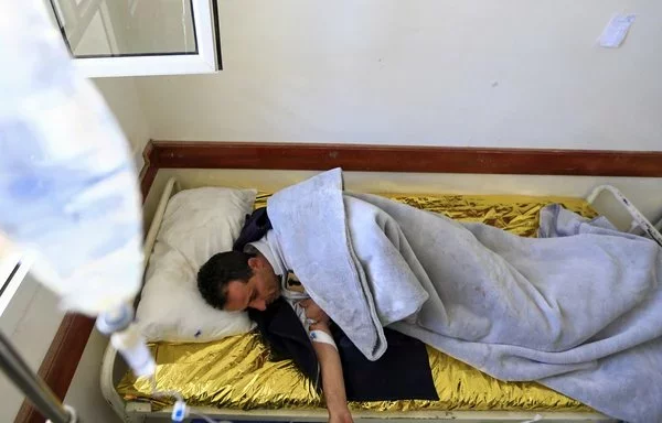 A Yemeni man lies on a bed at a cholera treatment center in Sanaa on April 25, 2019. [Mohammed Huwais/AFP]