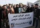 
Protesters hold pictures of children's bodies and a banner reading 'Erbil remains resilient, and it does not kneel down to terrorist attacks' during a demonstration January 16 outside the United Nations (UN) office in Erbil, a day after several areas in the city were hit by a missile attack launched by Iran's IRGC. [Safin Hamid/AFP]        