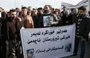 
Protesters hold pictures of children's bodies and a banner reading 'Erbil remains resilient, and it does not kneel down to terrorist attacks' during a demonstration January 16 outside the United Nations (UN) office in Erbil, a day after several areas in the city were hit by a missile attack launched by Iran's IRGC. [Safin Hamid/AFP]        