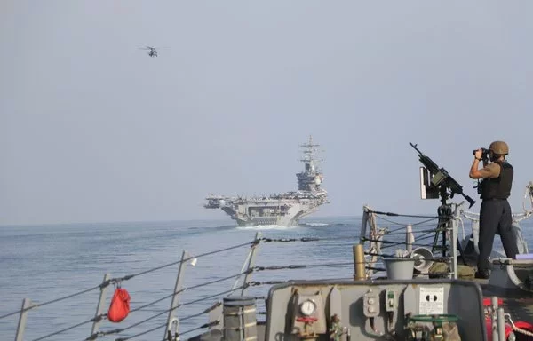 US and French military vessels and aircraft transit the Strait of Hormuz on November 26. [US Navy]