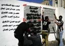 
Yemeni graffiti artists paint a text on a wall in memory of the victims of an al-Qaeda attack during a March 2014 anti-terrorism campaign in Sanaa. [Mohammed Huwais/AFP]        