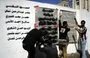 
Yemeni graffiti artists paint a text on a wall in memory of the victims of an al-Qaeda attack during a March 2014 anti-terrorism campaign in Sanaa. [Mohammed Huwais/AFP]        