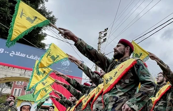 Hizbullah fighters parade in the southern Lebanese village of Jibchit on February 15. [Mahmoud Zayyat/AFP]