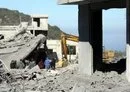 
Residents and rescuers check destruction in the southern Lebanese village of Kafra, on February 29, amid cross-border tensions between Israel and Hizbullah. [Mahmoud Zayyat/AFP]        