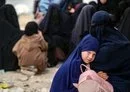 
A girl hugs her mother at al-Hol camp in Syria in 2023. [Delil Souleiman/AFP]        