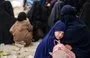 
A girl hugs her mother at al-Hol camp in Syria in 2023. [Delil Souleiman/AFP]        