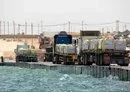 
Trucks deliver aid to Gaza via the newly operational pier constructed by the US military. [CENTCOM]        