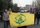 
The flag of the IRGC-controlled Fatemiyoun Division, a militia comprised of Afghan fighters formed in 2014 to fight in Syria, is carried through Tehran on January 12, with a portrait of the late IRGC Quds Force commander Qassem Soleimani. [AFP]        