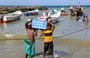 
Fishermen unload their catch upon reaching shore in Yemen's al-Khokha district, south of al-Hodeidah on April 21. [Khaled Ziad/AFP]        