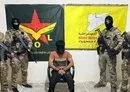 
Members of the SDF special forces surround an ISIS emir arrested in the Syrian city of al-Raqa. [SDF Press Center]        