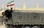 
A Syrian boy holds the Iranian flag atop a truck carrying aid in the eastern city of Deir Ezzor on September 20, 2017. [Louai Beshara/AFP]        