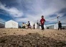 
Children play at Roj camp in Syria's al-Hasakeh province, where relatives of suspected members of ISIS are held, on October 8. [Delil Souleiman/AFP]        