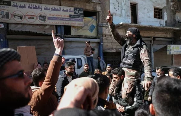 Demonstrators rally in the Idlib province town of Binnish on March 1 to protest against Tahrir al-Sham. [Oman Haj Kadour/AFP]