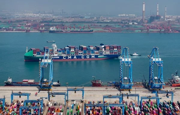 A cargo ship on May 14 loaded with containers at a port in Qingdao, in China's Shandong province. [AFP]