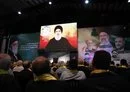 
In Beirut's southern suburb, supporters watch Hizbullah chief Hassan Nasrallah deliver a televised speech on May 24. [Anwar Amro/AFP]        